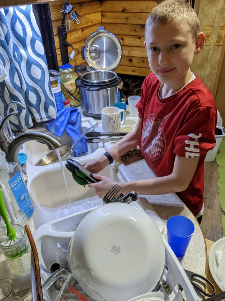 Lukas working on dinner dishes