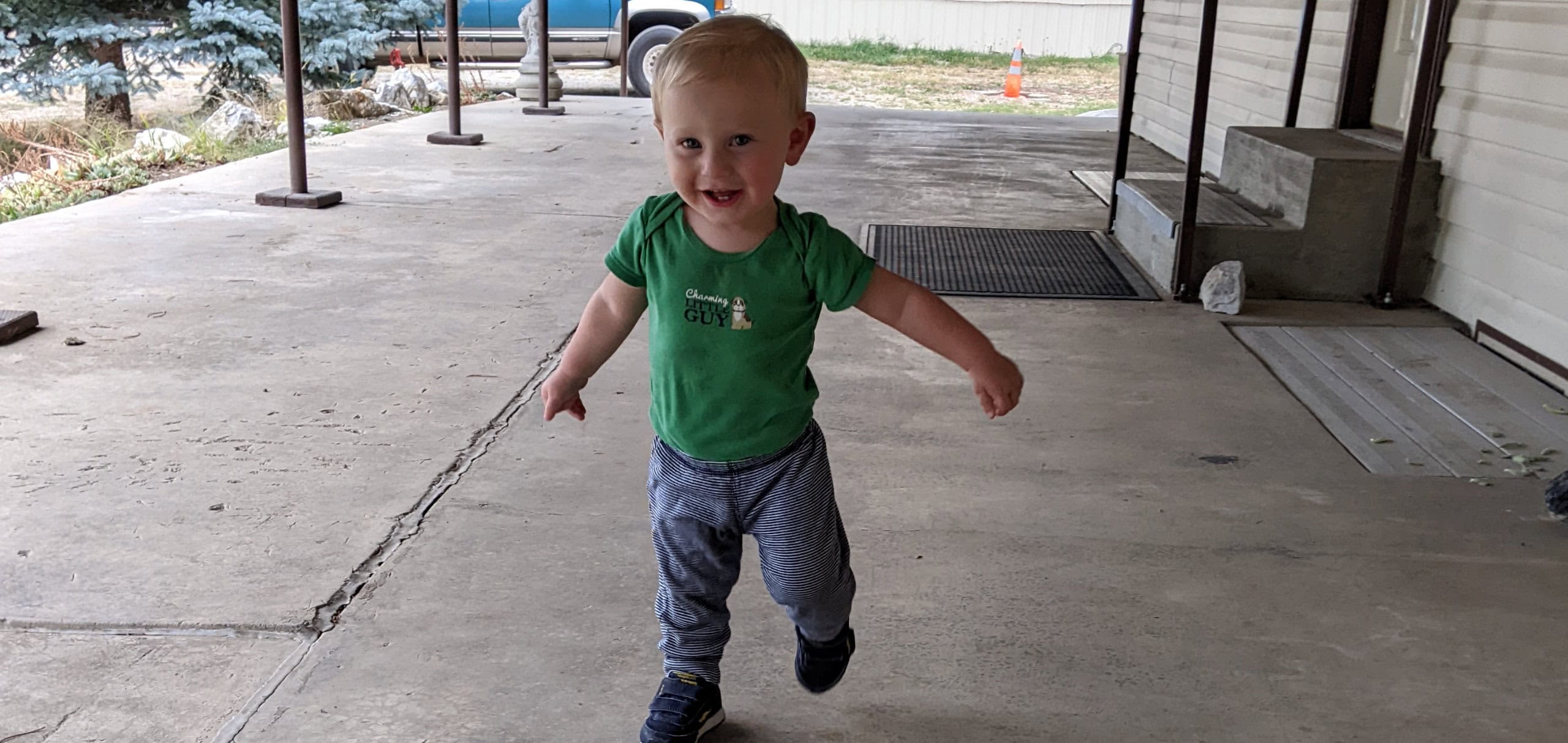 Child learning to walk outside