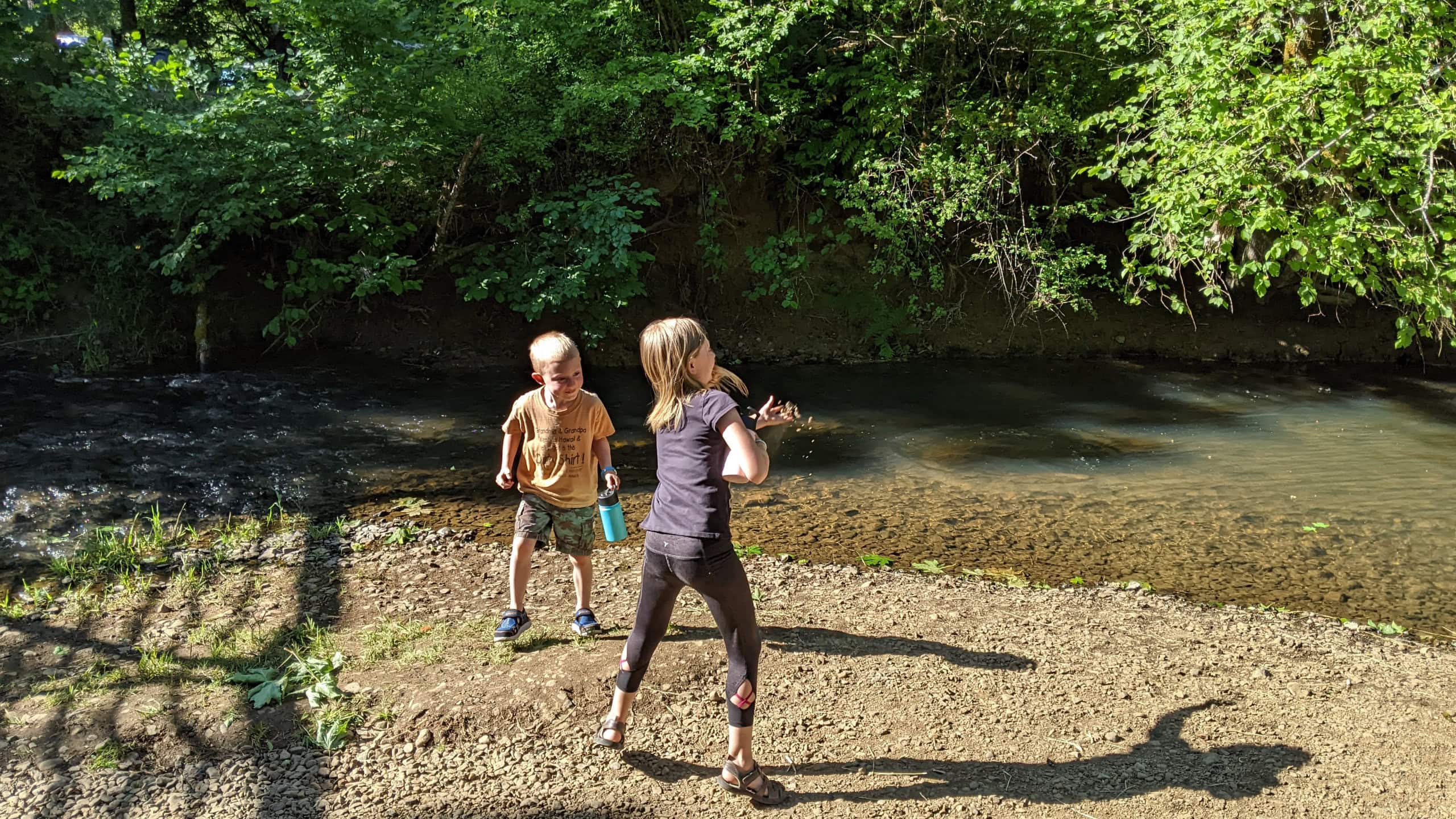 Kids play by the water on a hot day