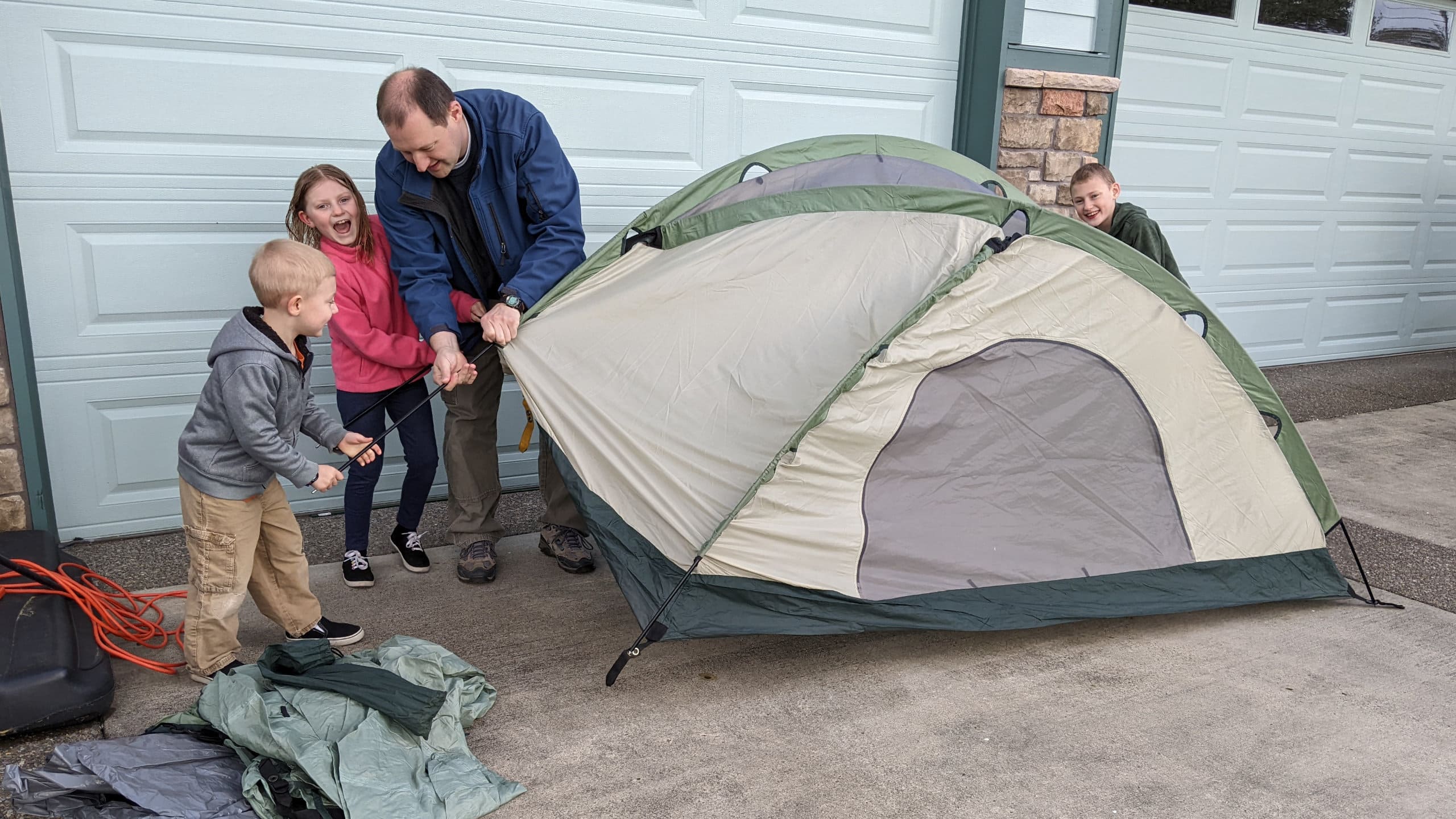 Alex teaching the kids how to set up a tent