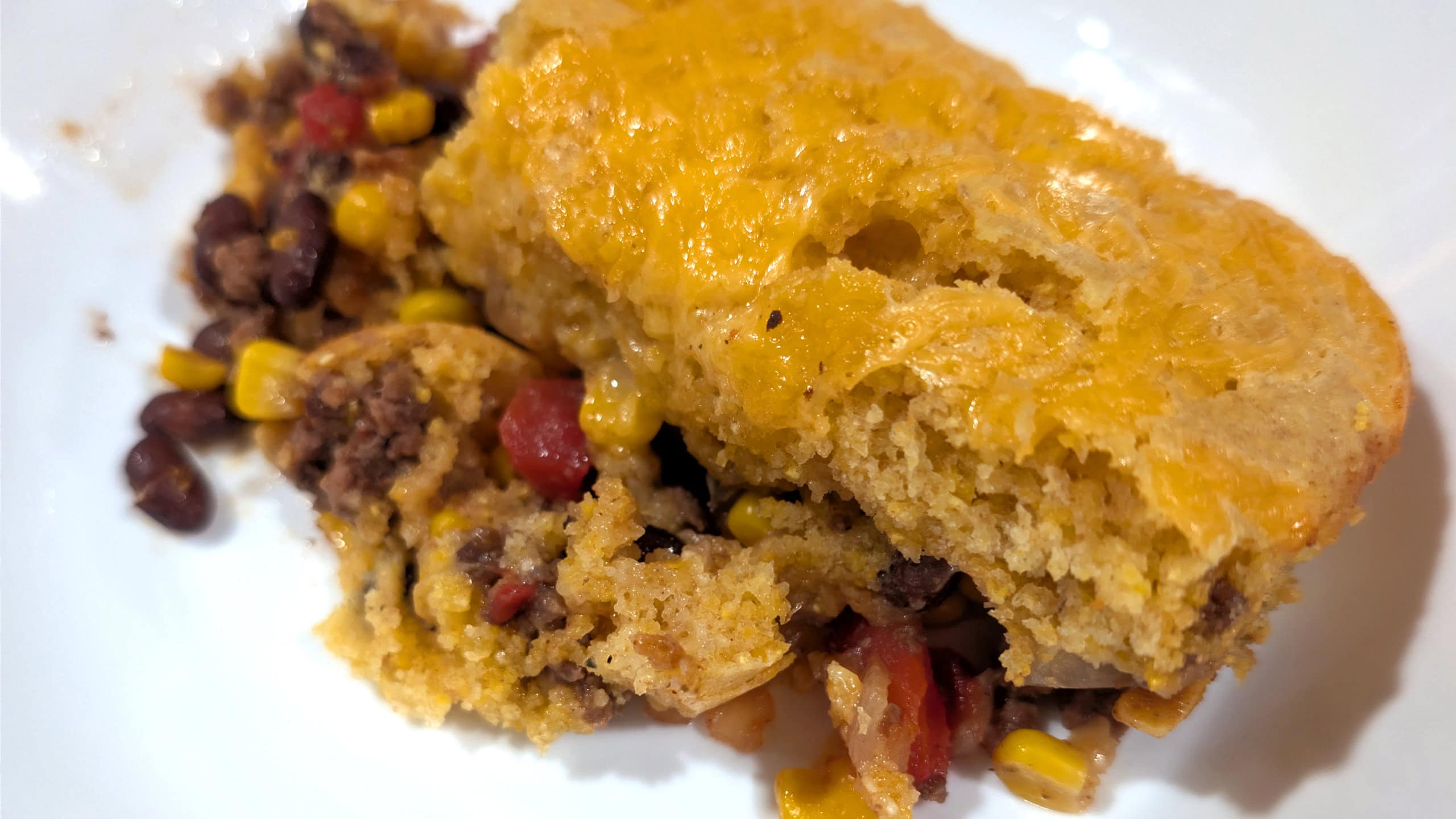 A slice of Taco Cornbread Casserole on white plate