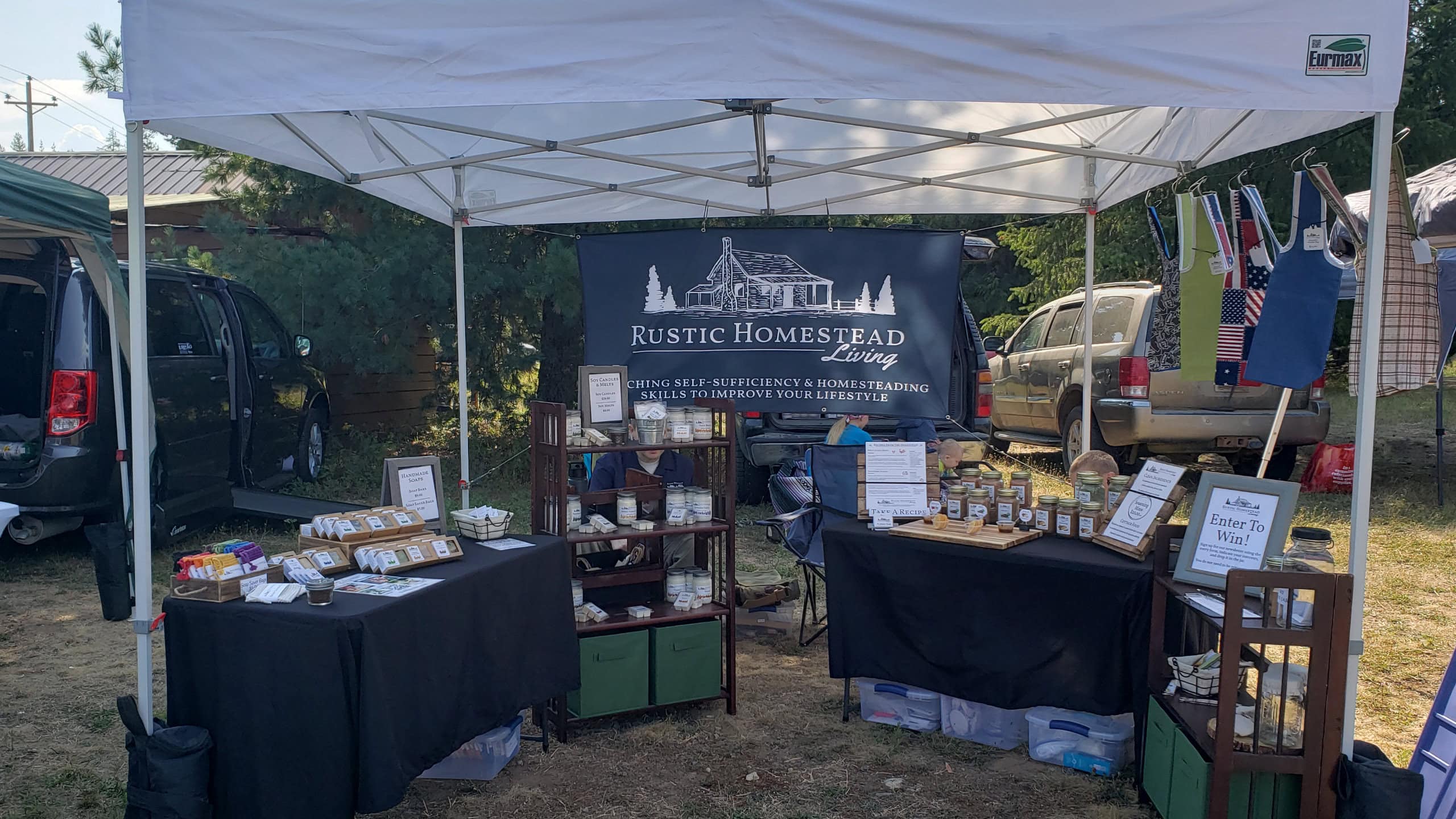 Rustic Homestead Living outdoor vendor booth, products under tent