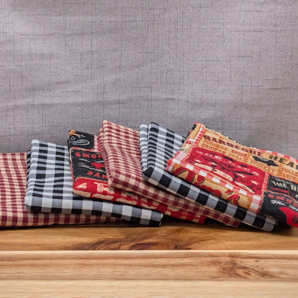 Set of fanned out reusable paper towels on wooden board in the backyard bbq pattern