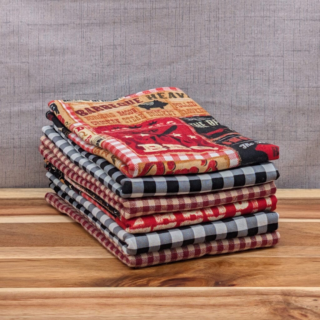 Set of folded reusable paper towels on wooden board in the backyard bbq pattern
