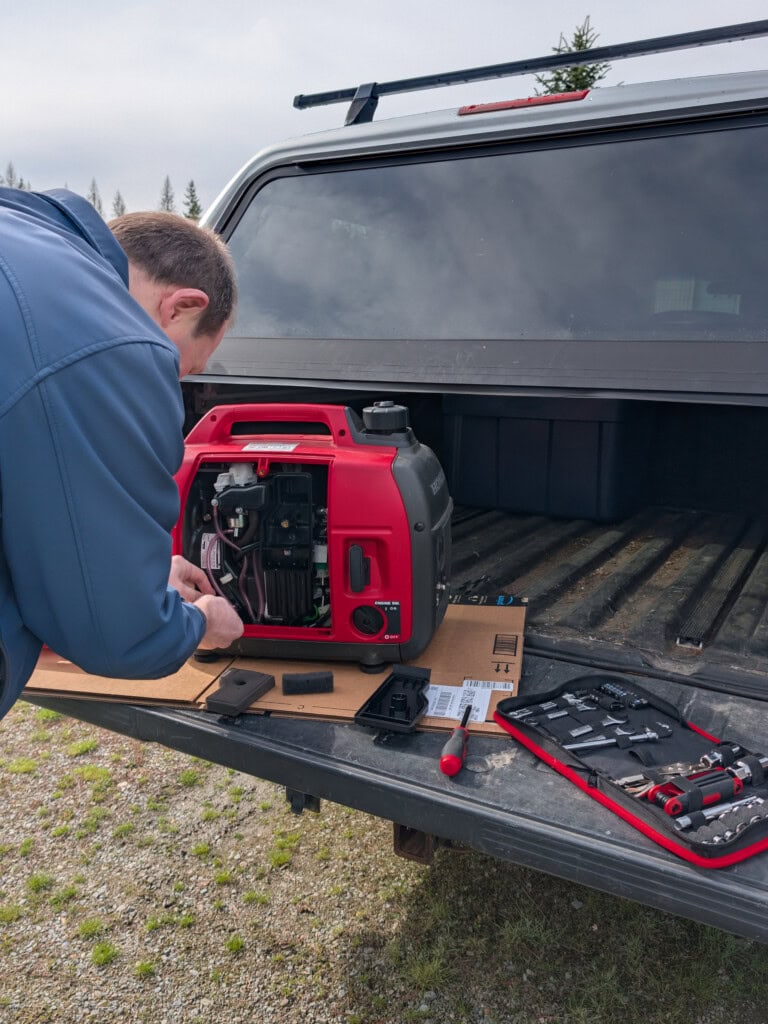 Father checking air filters and changing oil on generator