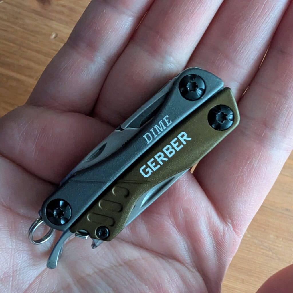Gerber Dime pocketknife in the palm of adult male hand