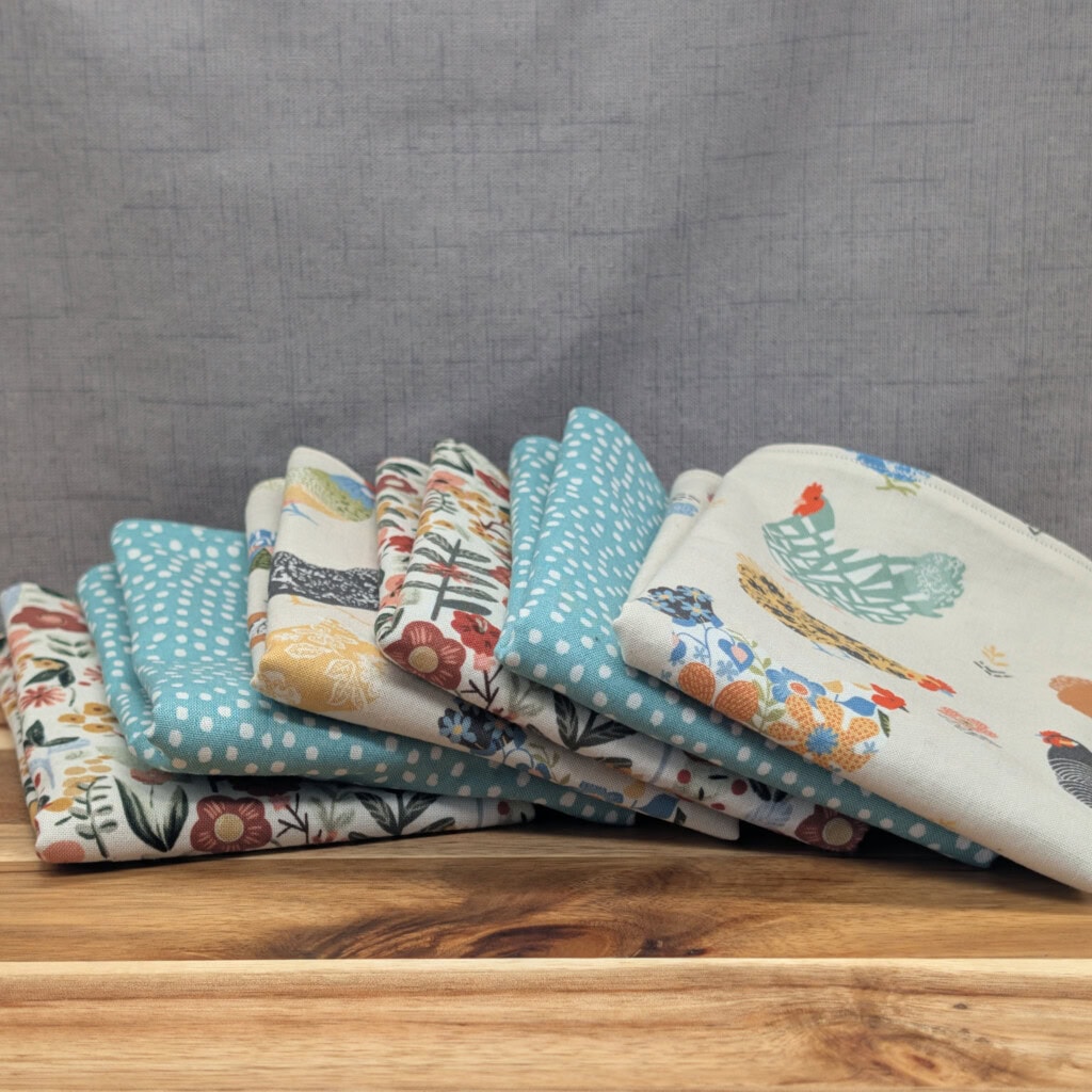 Set of fanned out reusable paper towels on wooden board in the farm & garden pattern