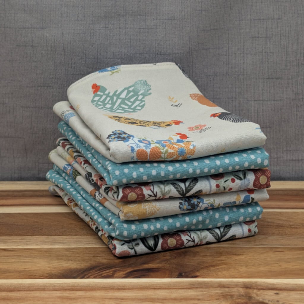 Set of folded reusable paper towels on wooden board in the farm & garden pattern
