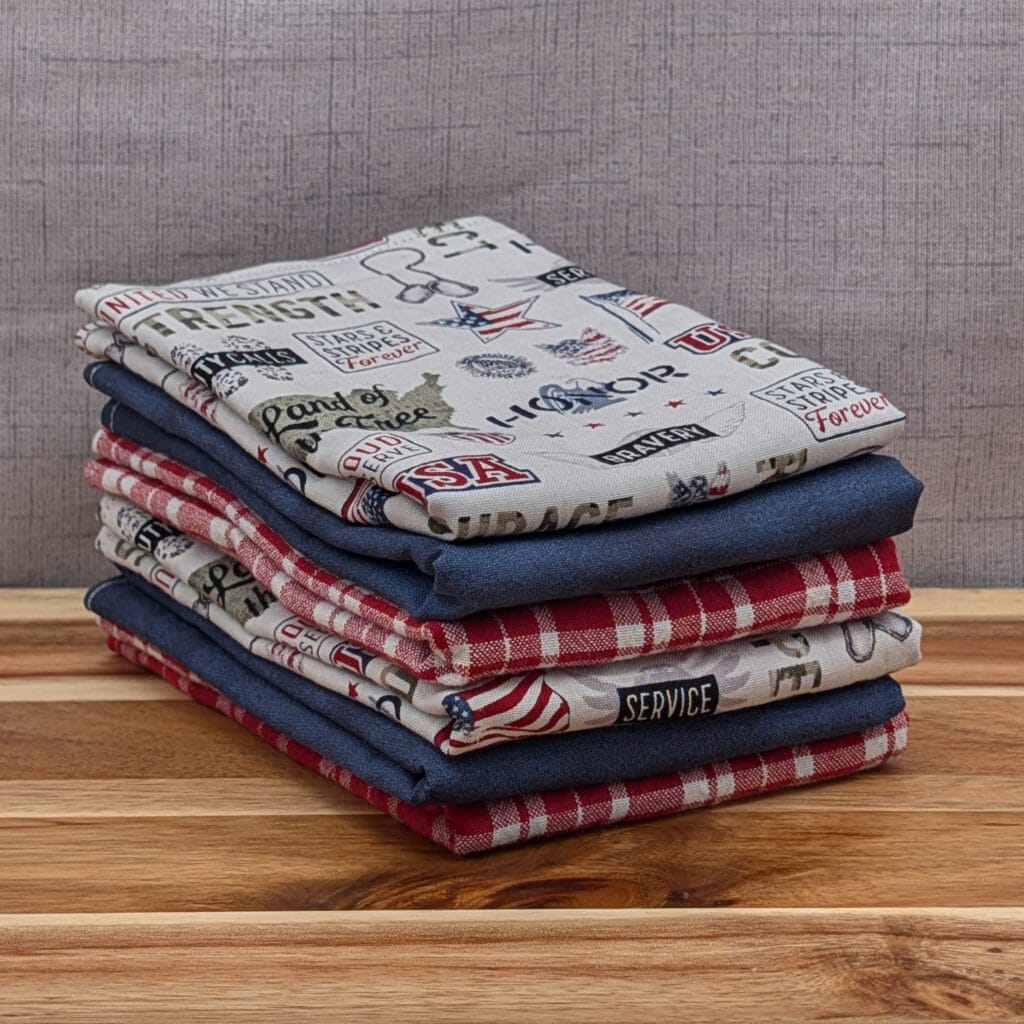 Set of folded reusable paper towels on wooden board in the freedom pattern