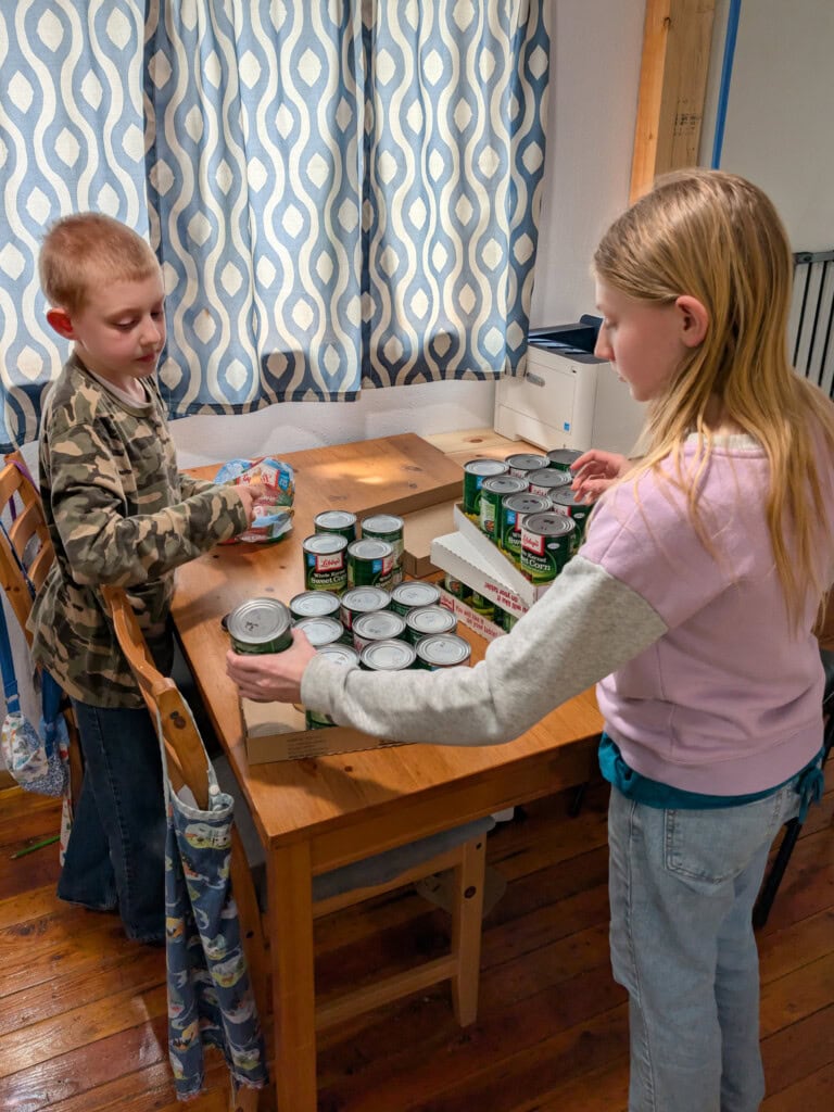 Young boy and girl rotating and checking canned food