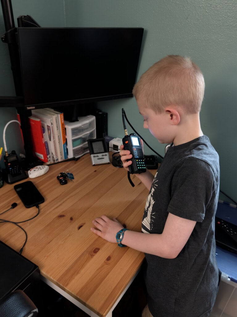 Young boy conducting a practice radio call