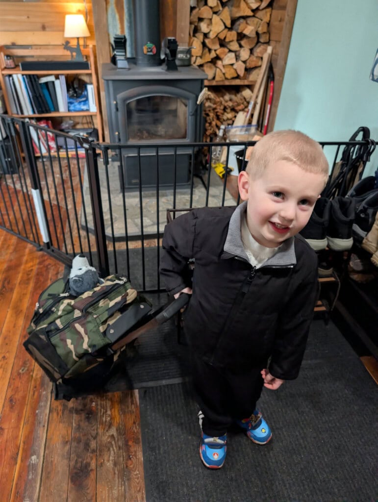 Young boy with 72-hour kit prepared to leave during drill