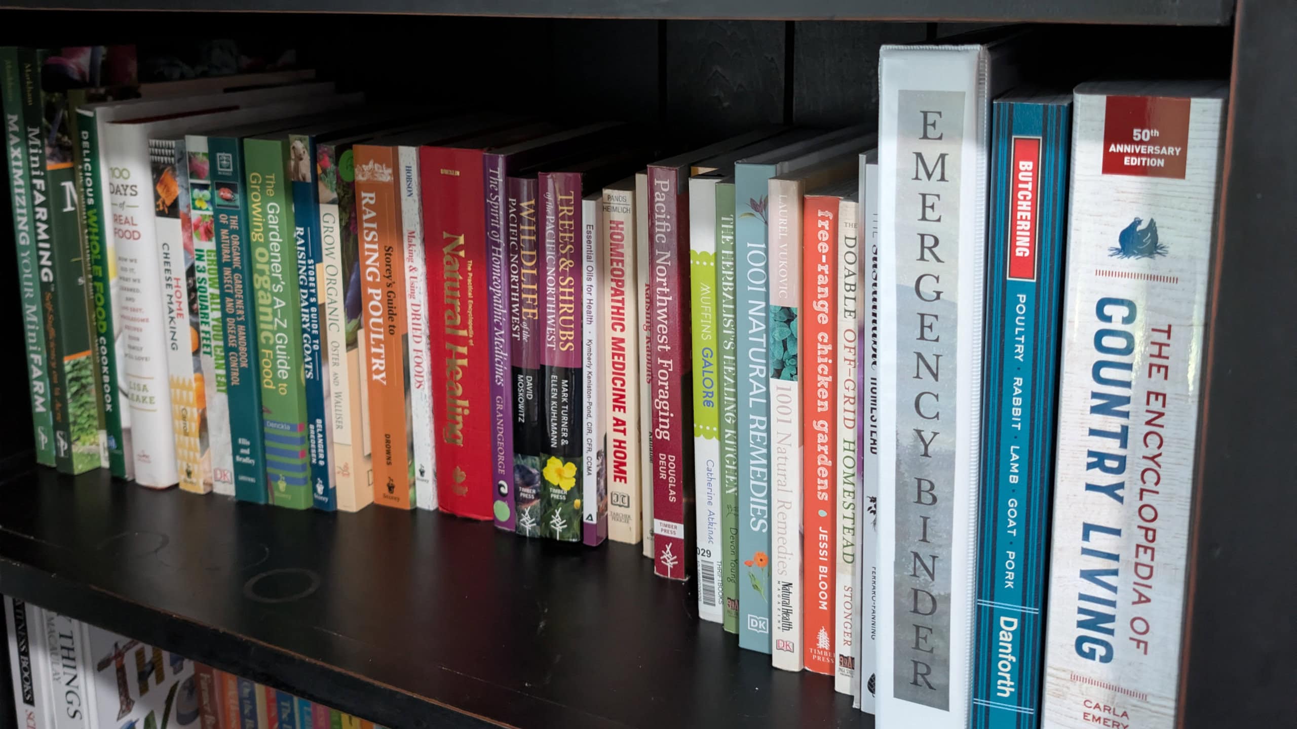 Homesteading & Preparedness books on a bookshelf