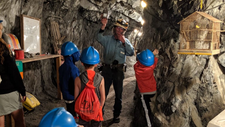 Kids and tour guide in a silver mine shaft