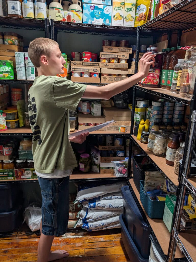 Teenage boy counting supplies and doing pantry math