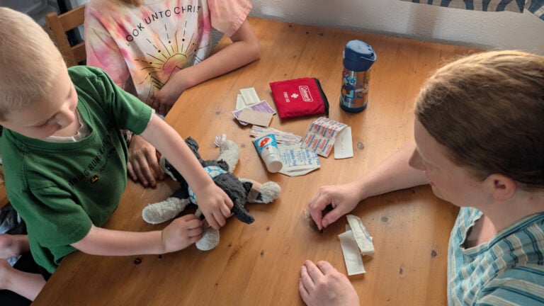 Mom teaching young son how to use his EDC kit