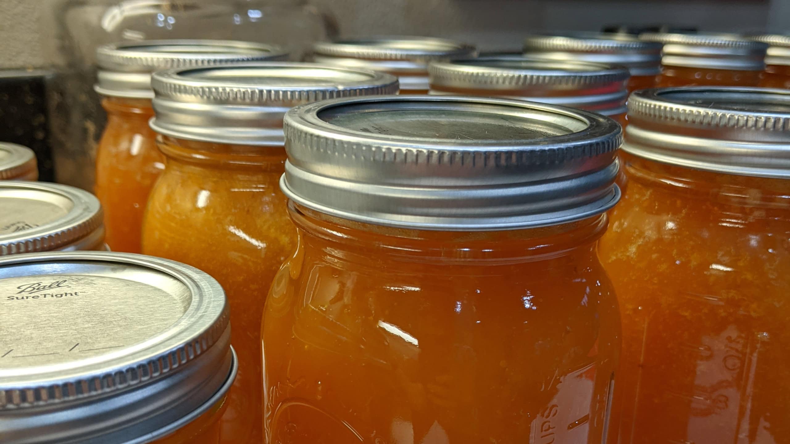 Jars of homemade preserves cooling after home canning