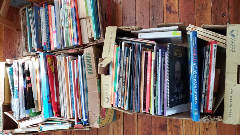 Boxes full of homeschool books on the floor